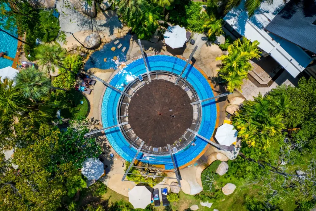 Aerial view of a circular natural hot spring pool at The Hotspring Beach Resort & Spa