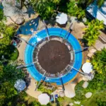 Aerial view of a circular natural hot spring pool at The Hotspring Beach Resort & Spa