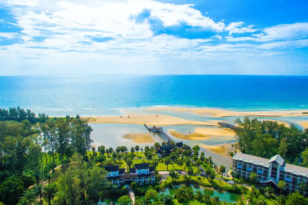 Aerial view of the quiet Natai Beach coastline and resort grounds in Phang Nga